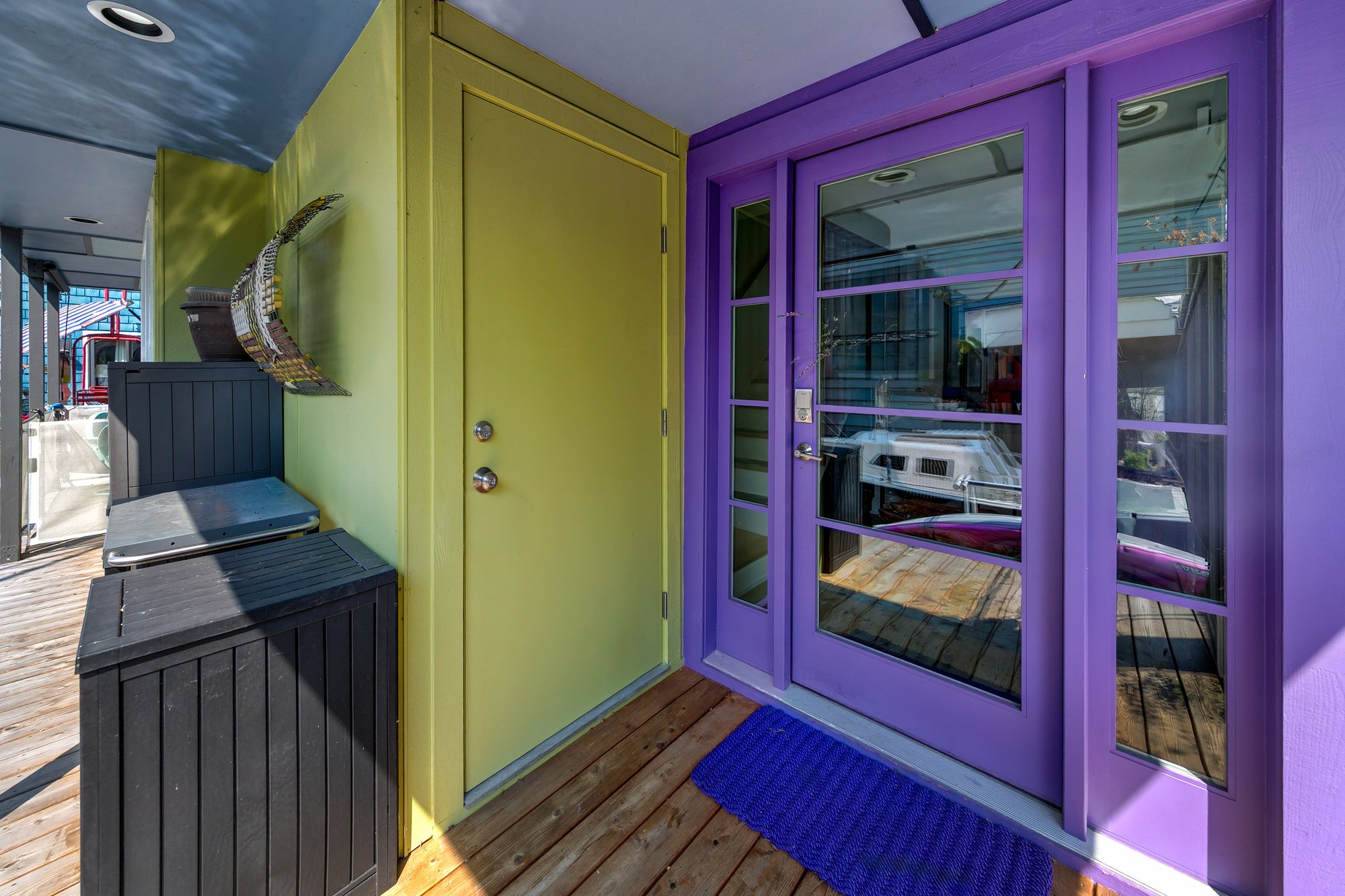Colorful entry door beneath the upper deck