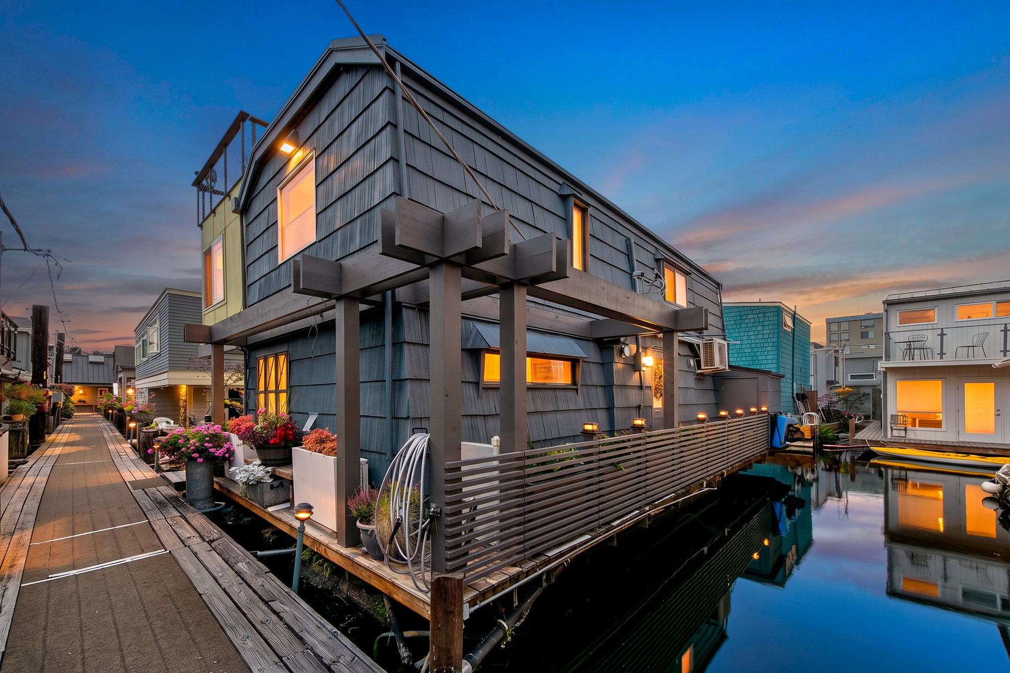 Waterside exterior of the Floating Home at dusk