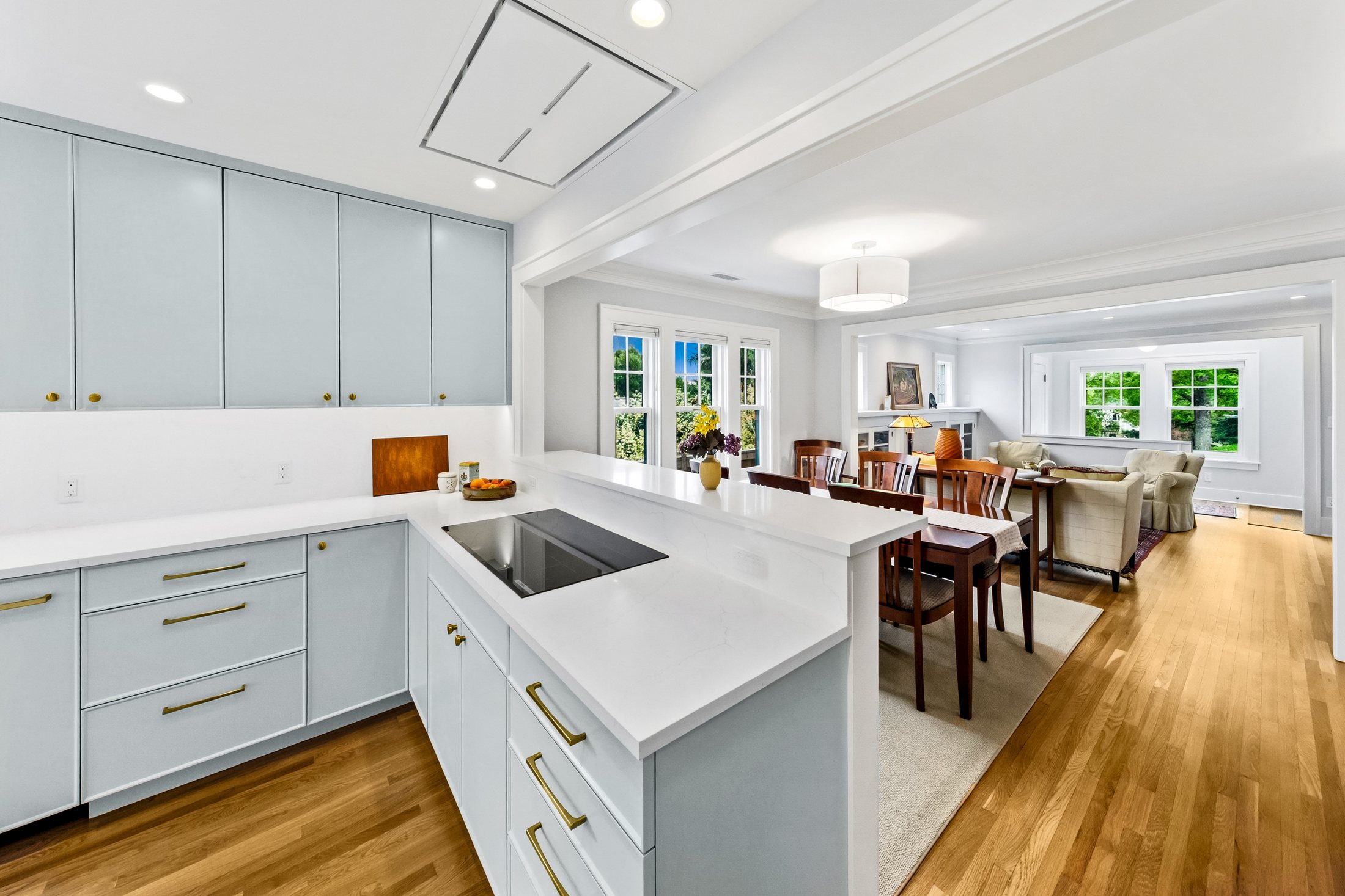 Tangletown kitchen remodel with light blue cabinetry and connected living spaces
