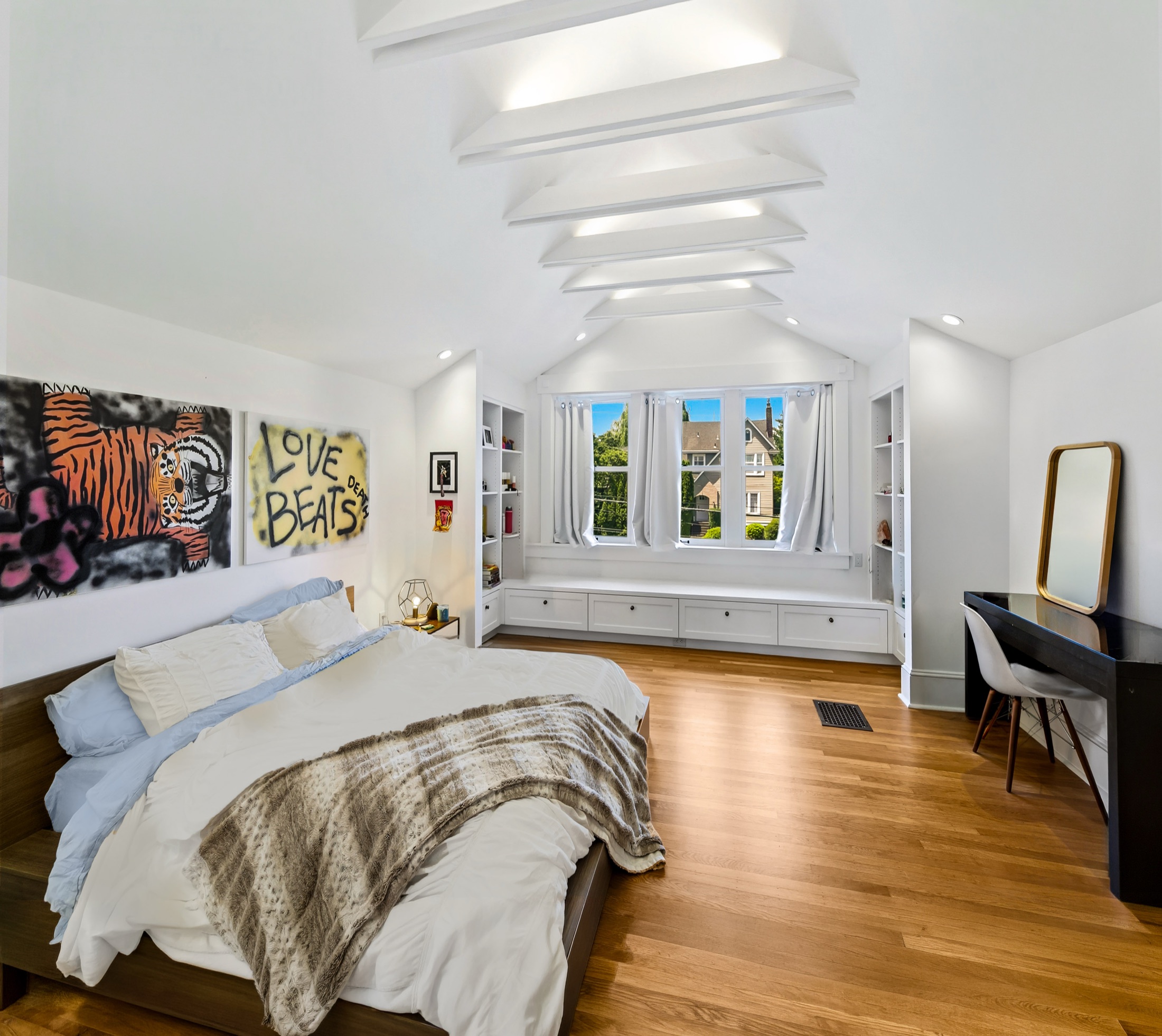 Madrona primary bedroom with vaulted ceiling and skylights