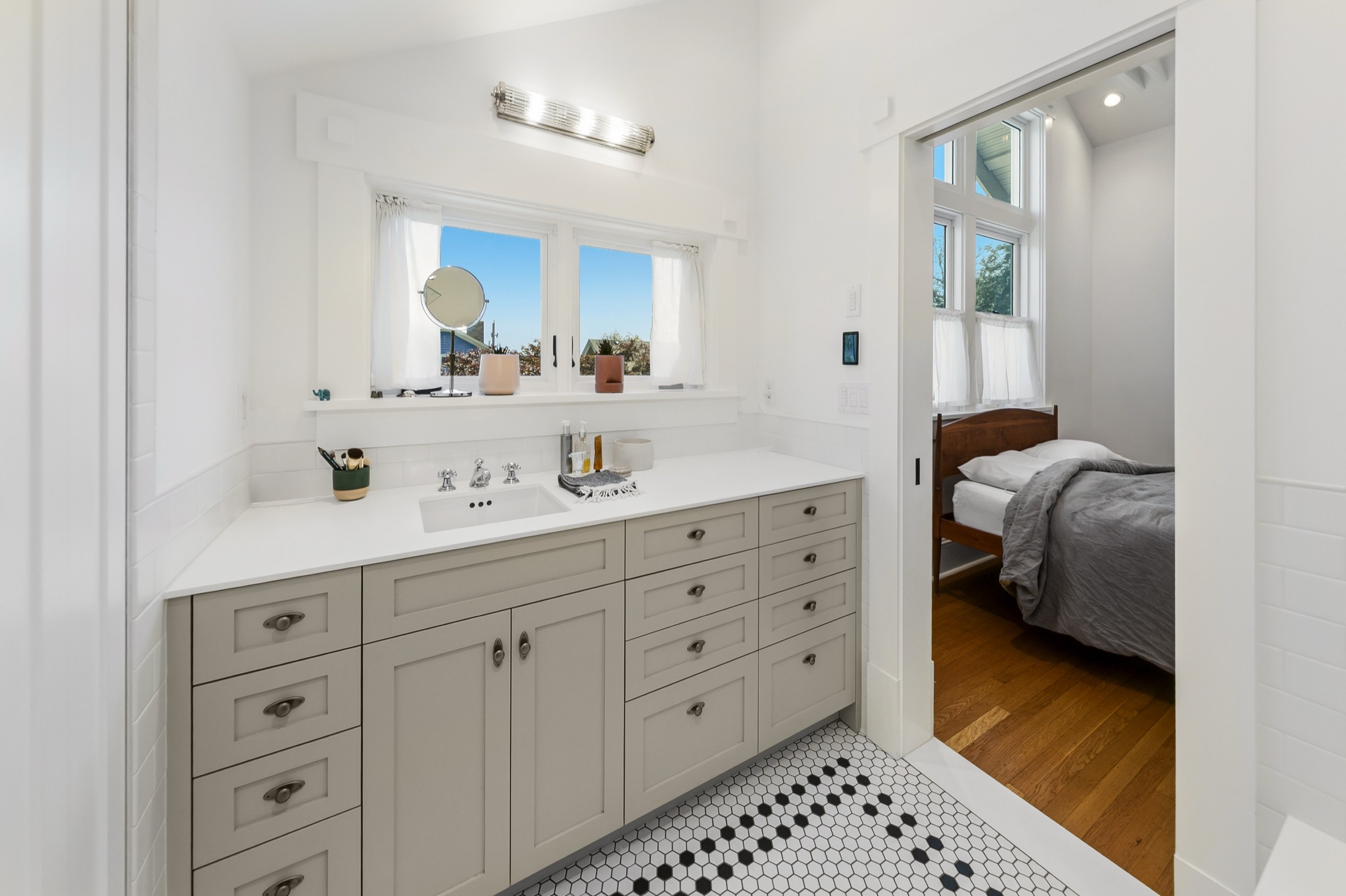 Custom double vanity connecting the bathroom and bedroom