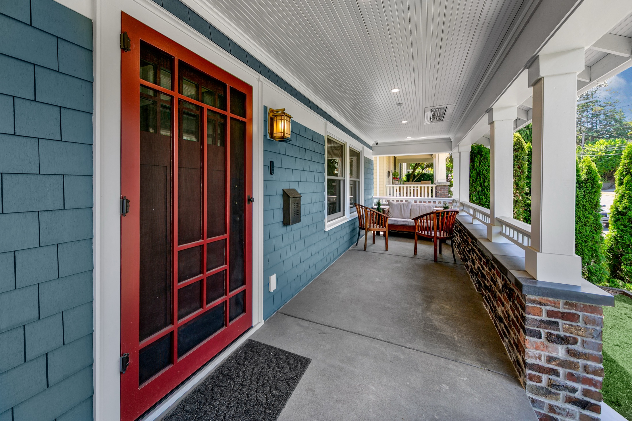 Covered front porch with red door and craftsman details