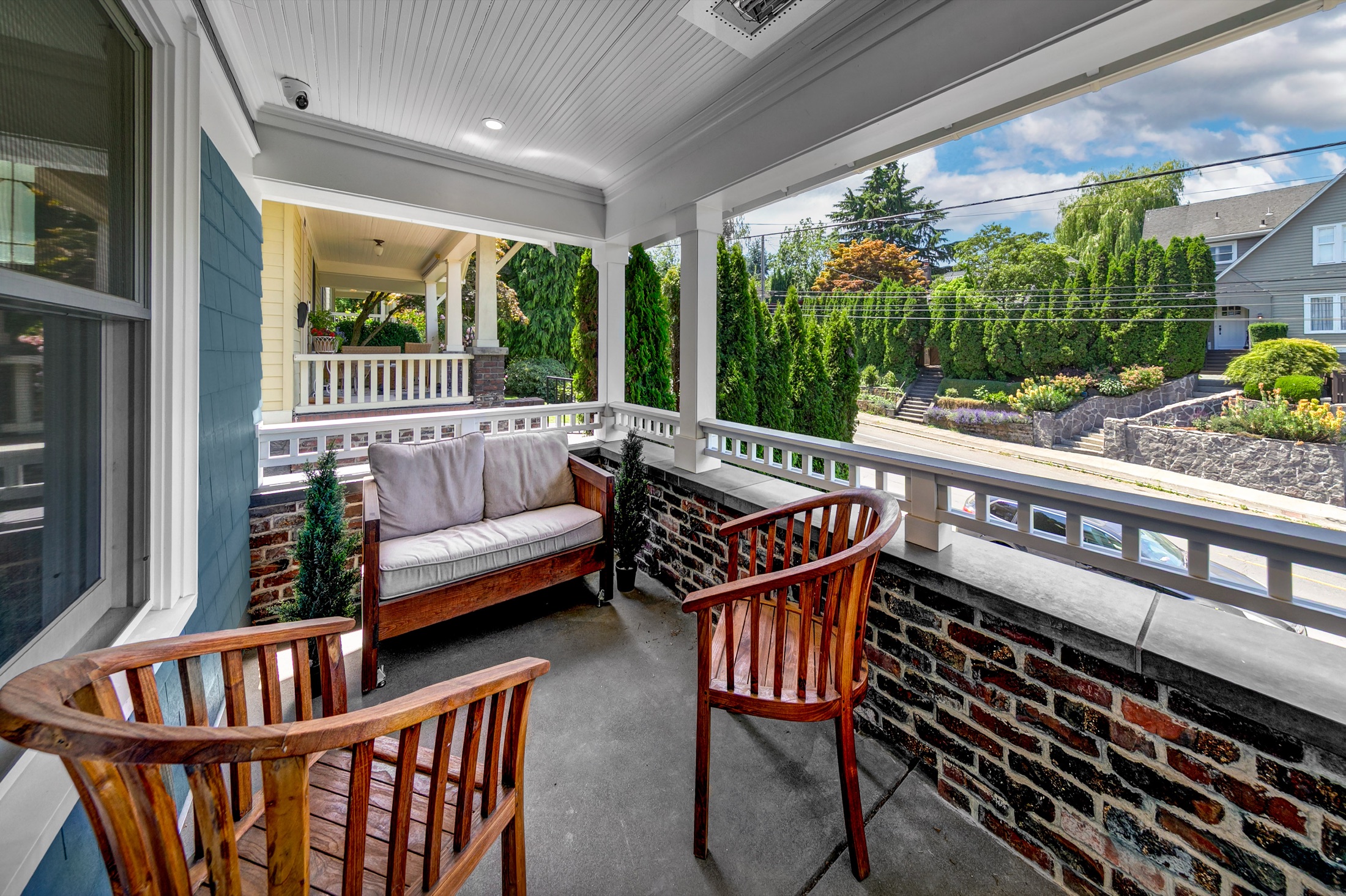 Front porch seating framed by reclaimed brick