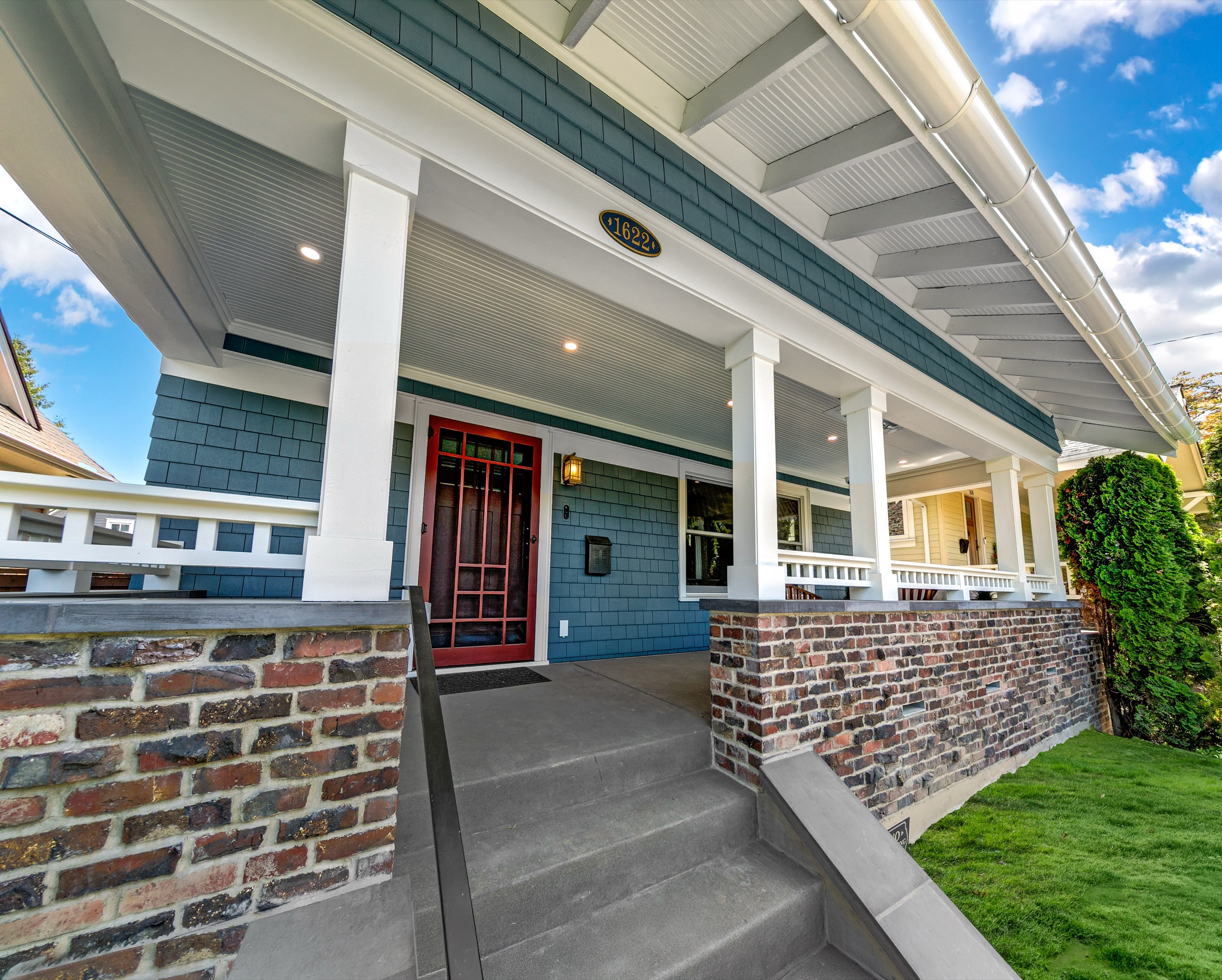 Madrona craftsman front porch with reclaimed brick and blue shingles