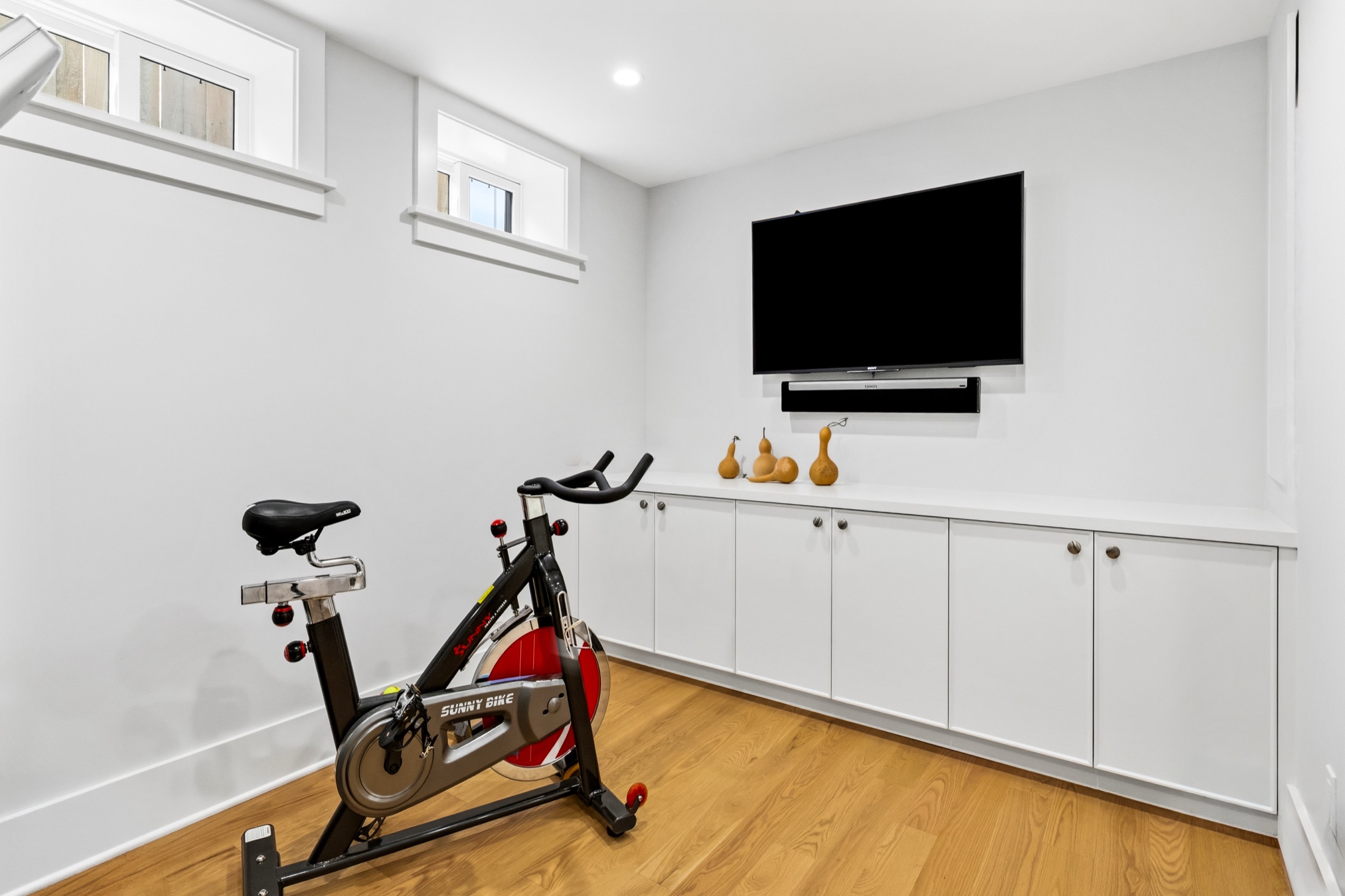 Flexible workout room with built-in storage cabinetry