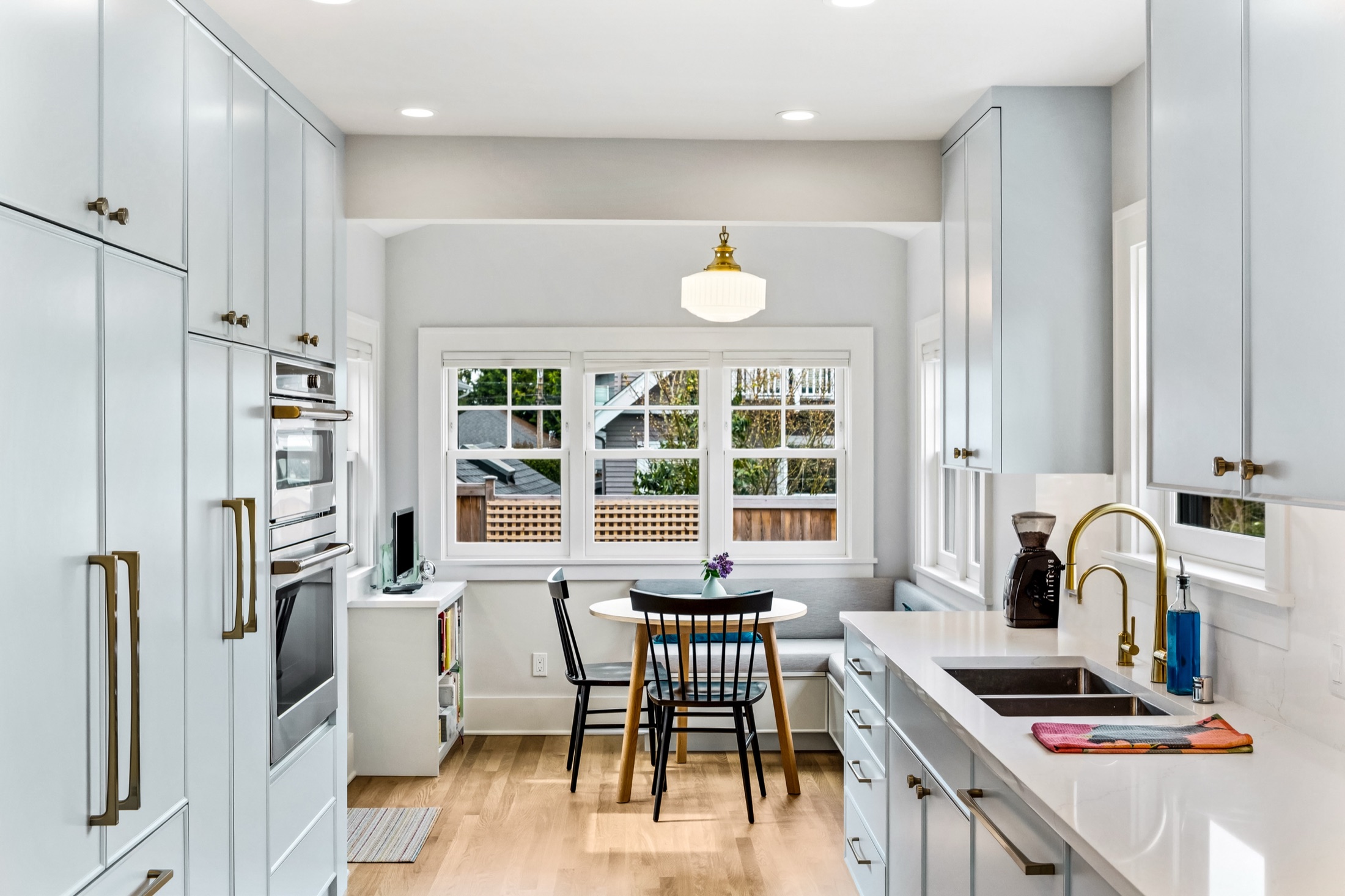 Kitchen with paneled appliances, double ovens, and breakfast nook