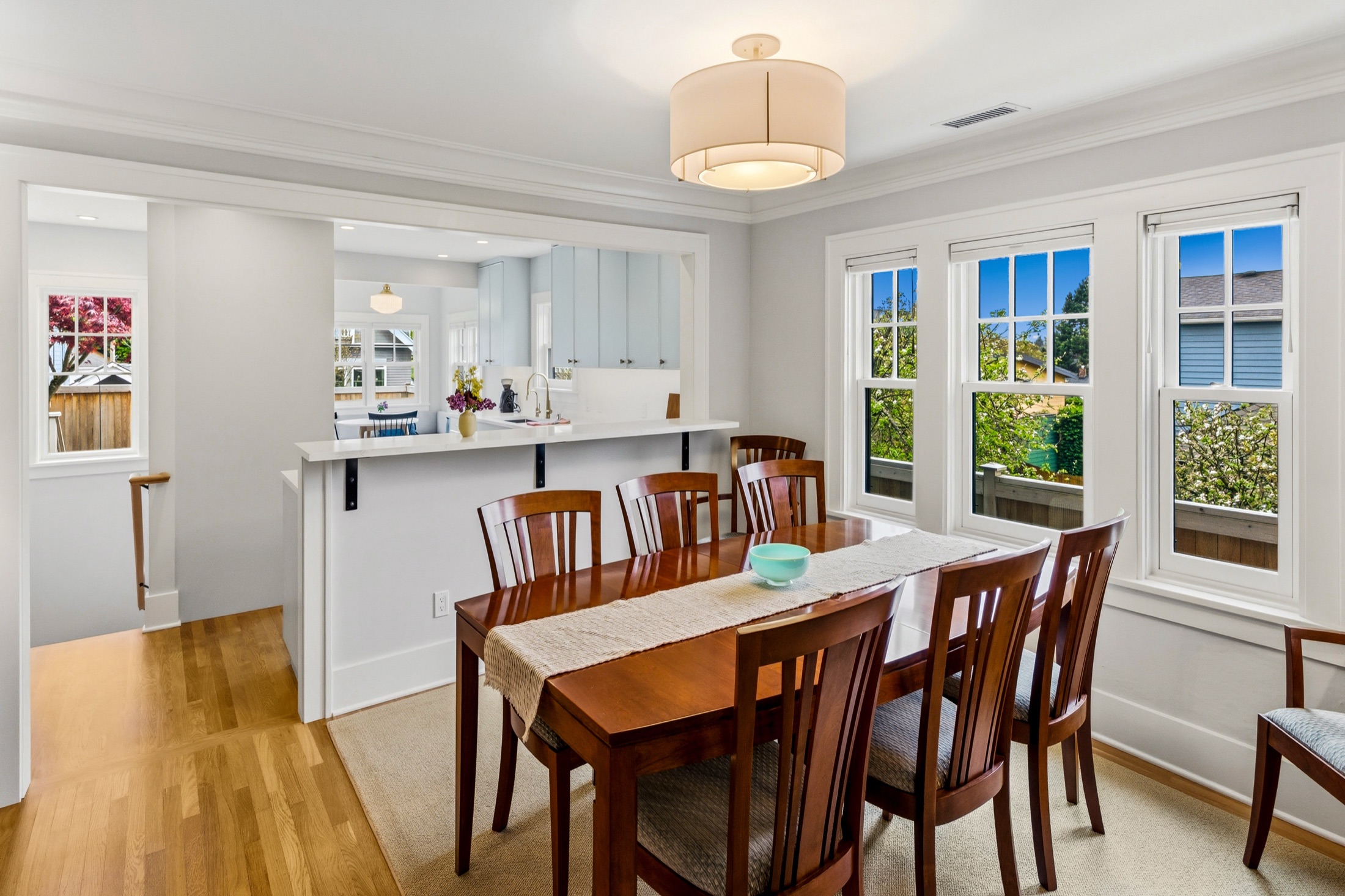Tangletown dining room with hardwood floors and garden windows