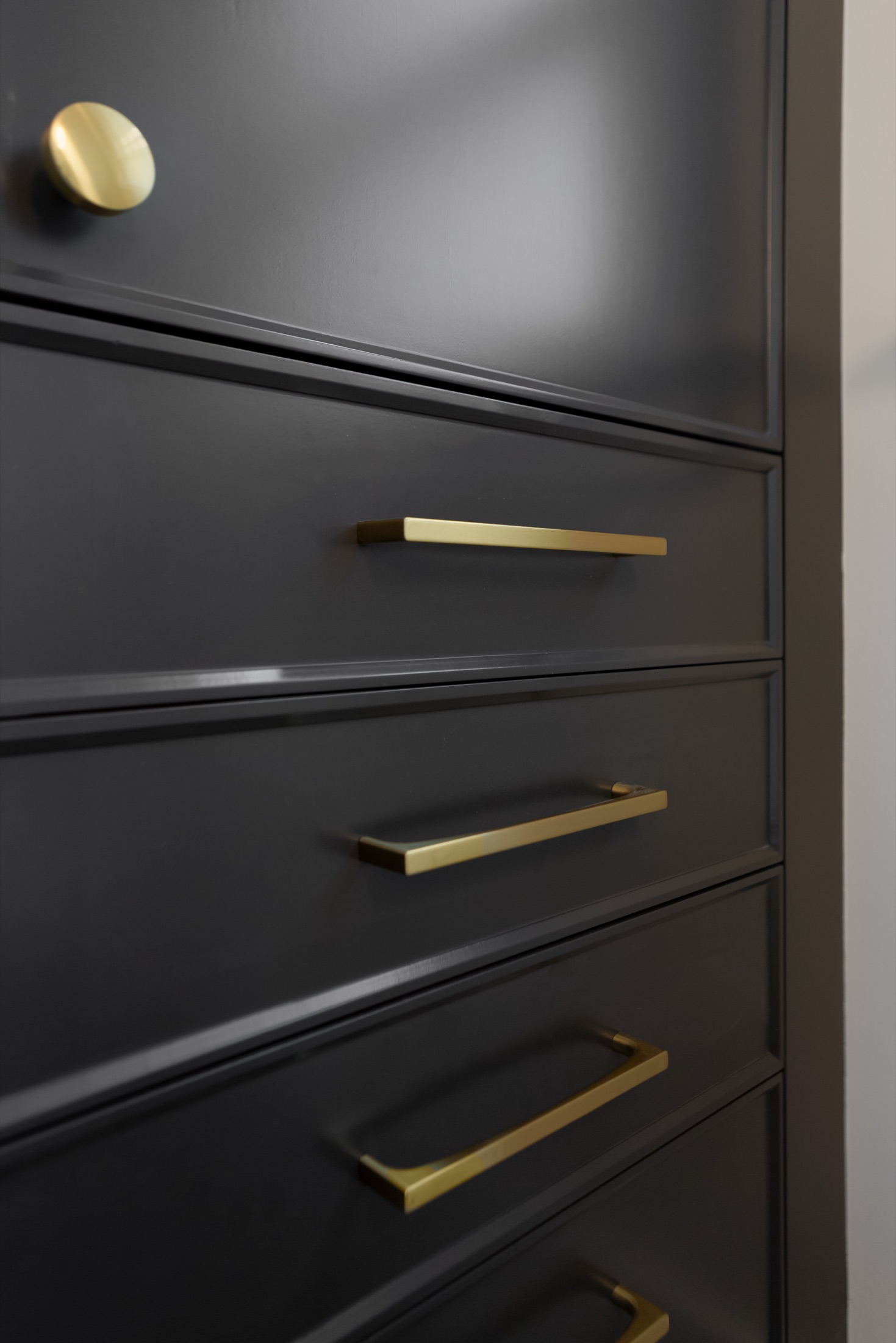 Dark vanity drawer with brass pull
