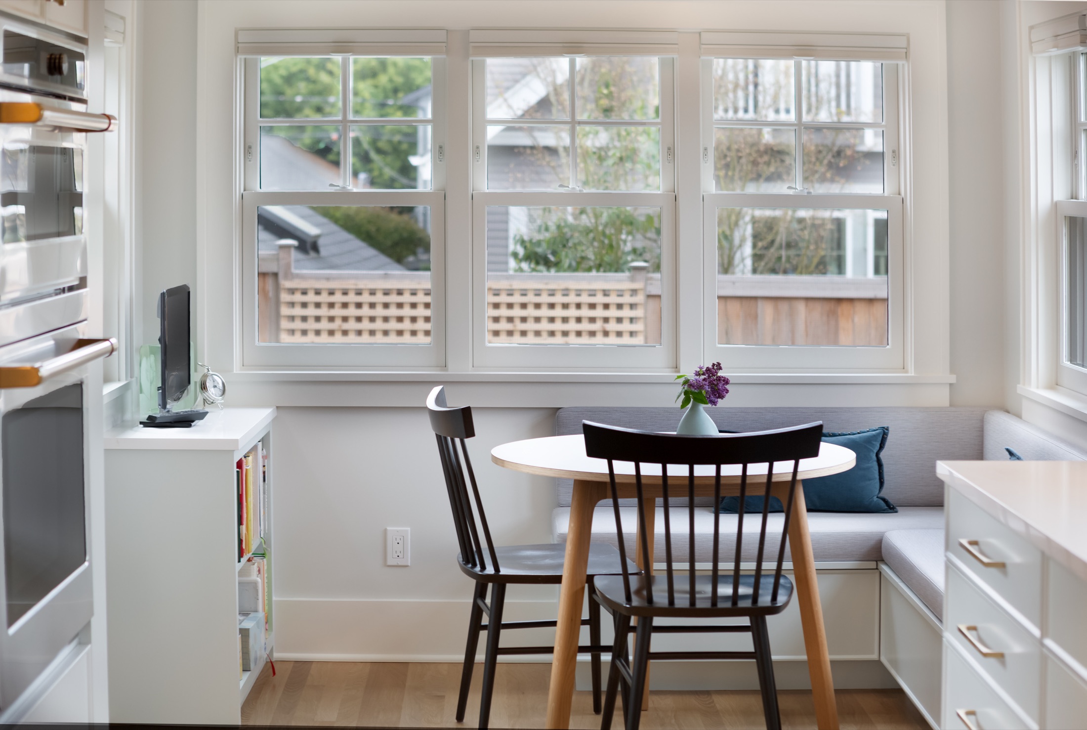Breakfast nook with built-in bench beneath garden windows