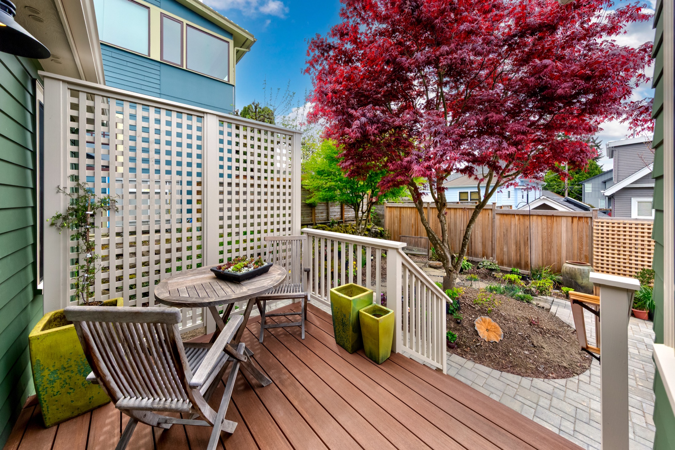 Tangletown deck with wood trellis overlooking the landscaped patio