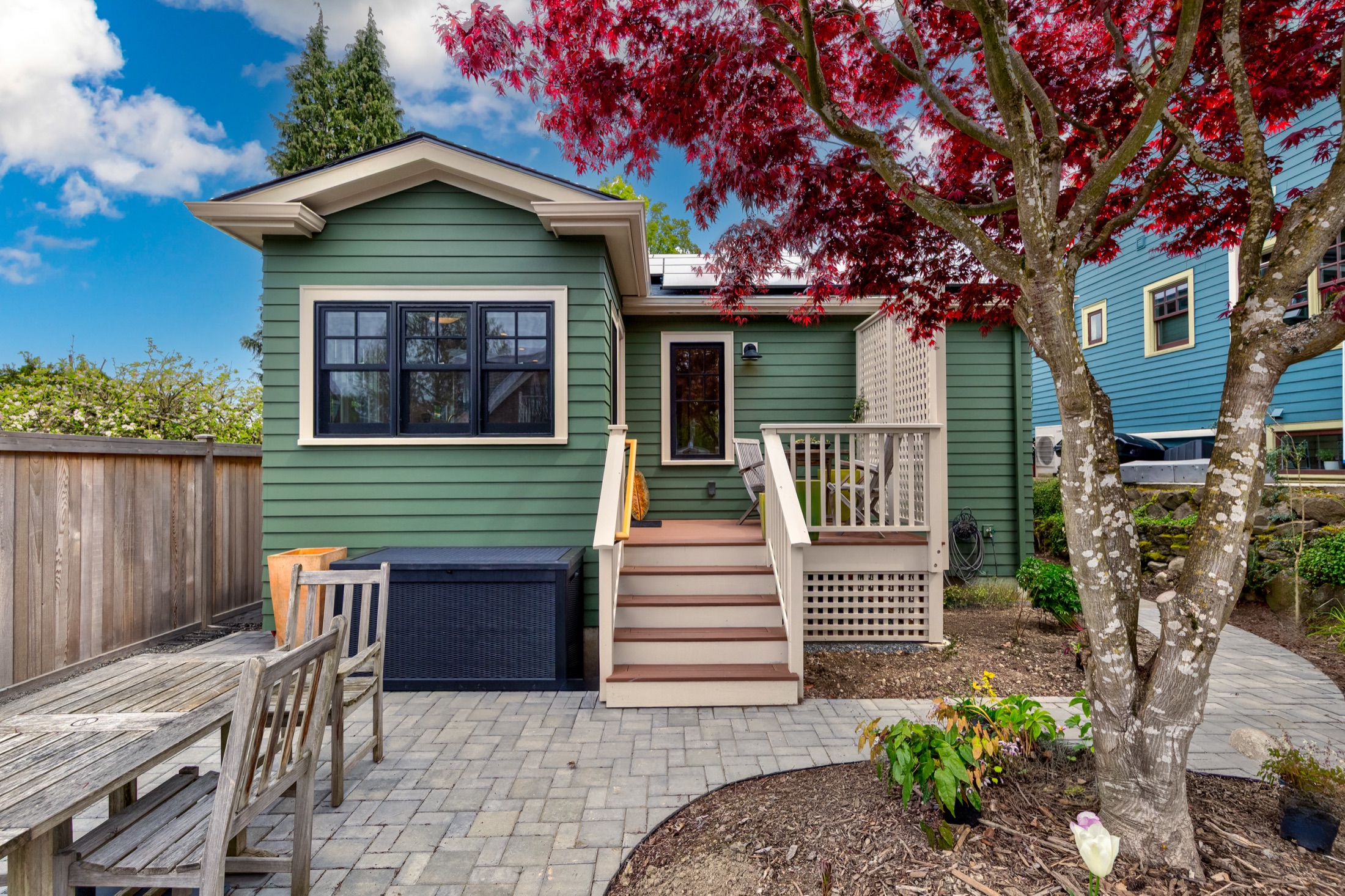 Green rear addition with steps connecting to the backyard