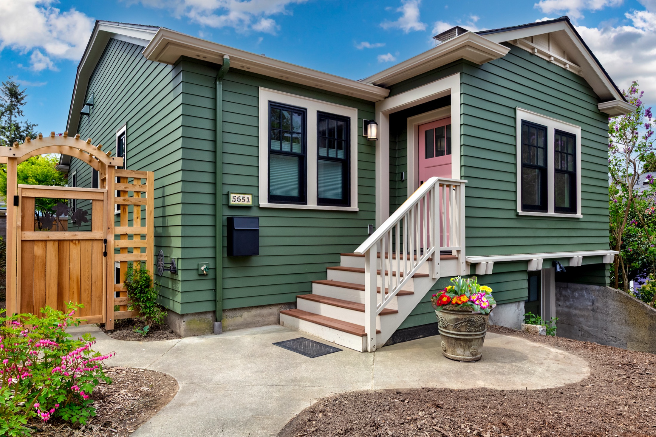 Rear addition with white-trimmed windows and patio access