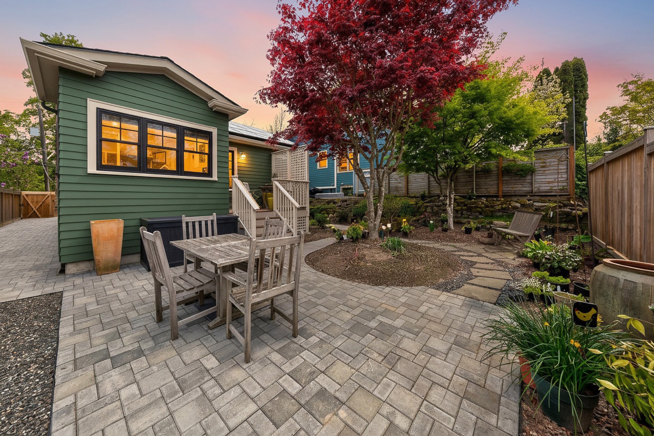 Landscaped backyard patio and green home addition