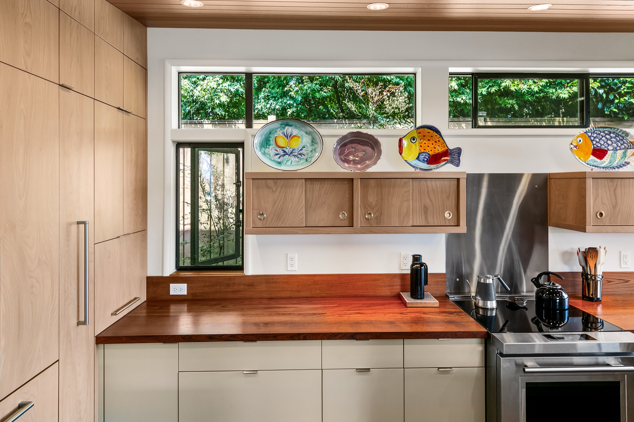MCM kitchen cooktop wall with custom upper and lower cabinetry