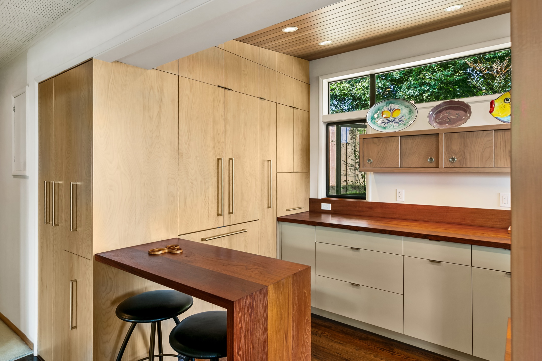 Custom light wood cabinetry and compact kitchen peninsula