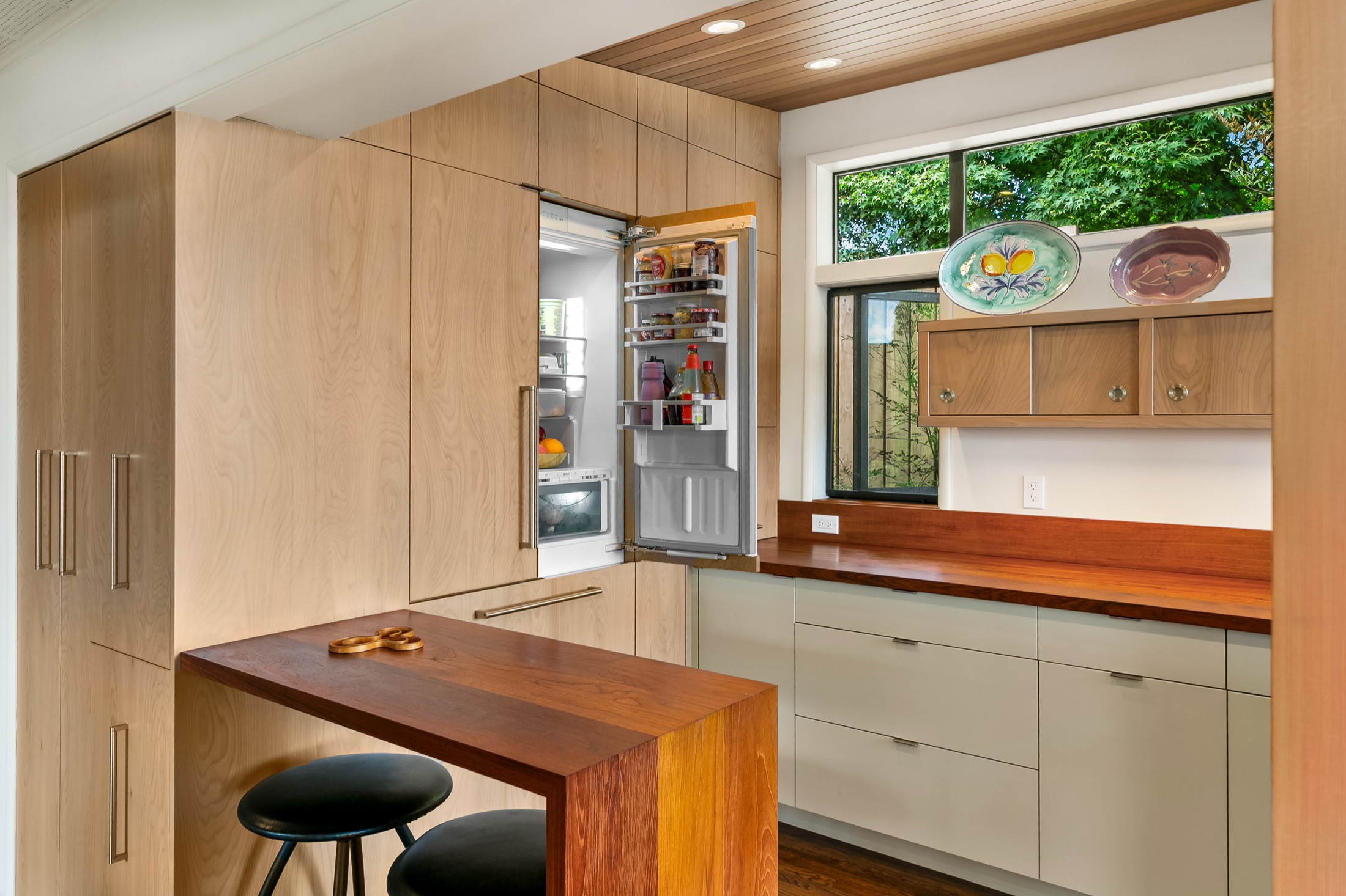 Integrated refrigerator opened within the pantry cabinetry