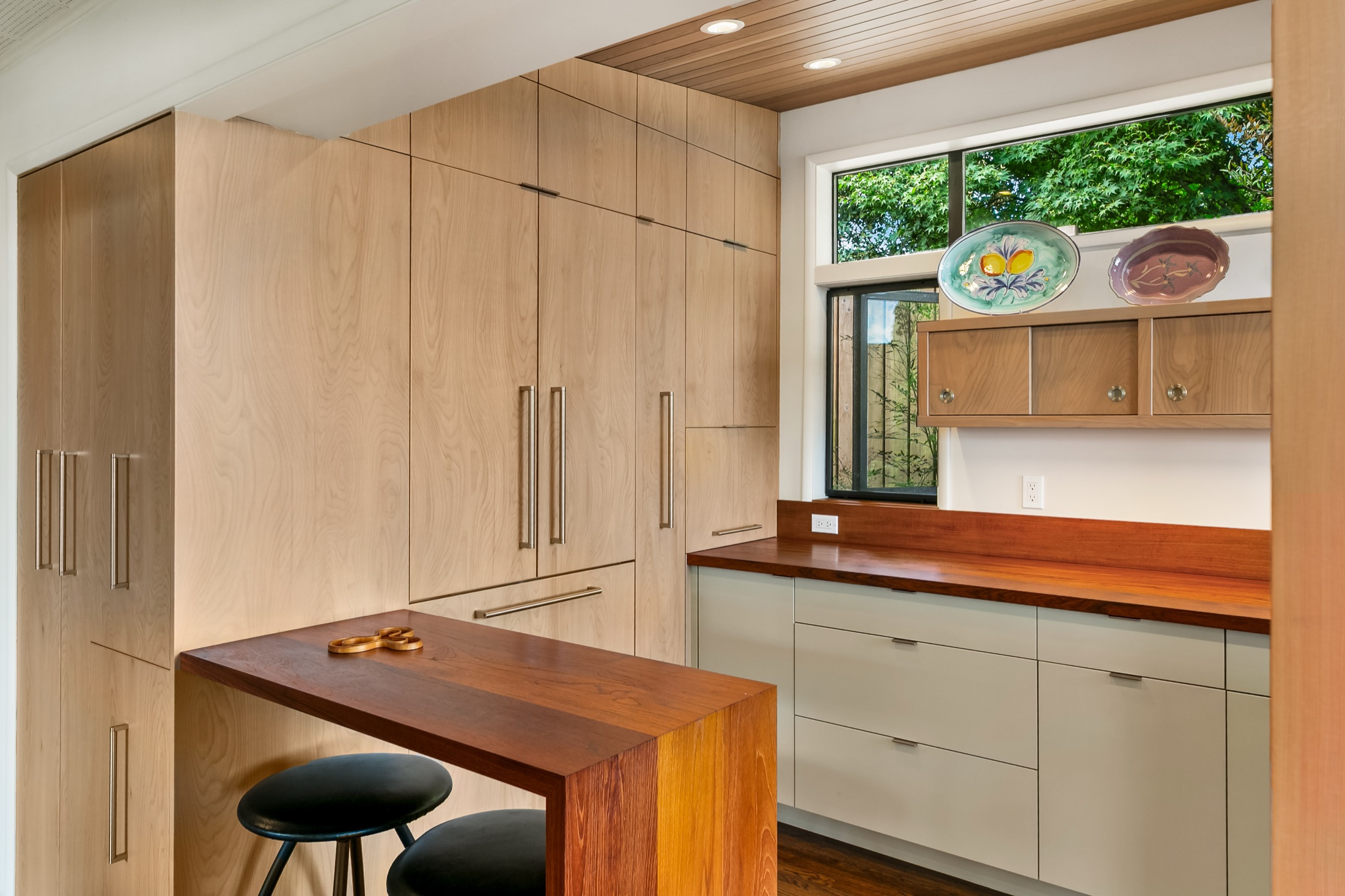 Paneled refrigerator closed within the custom pantry wall