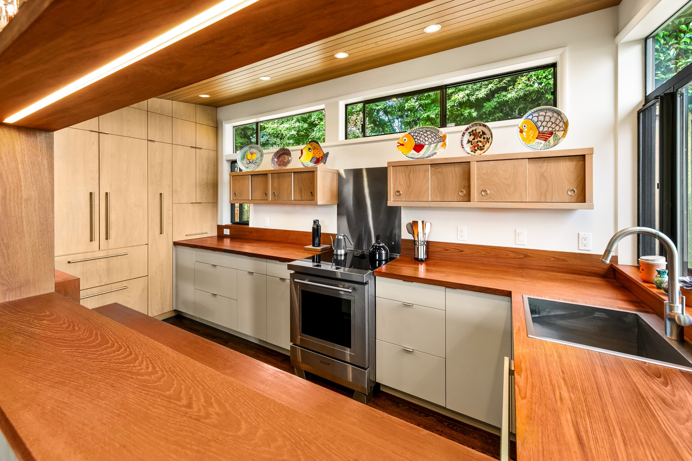Kitchen sink, wood counters, and clerestory windows