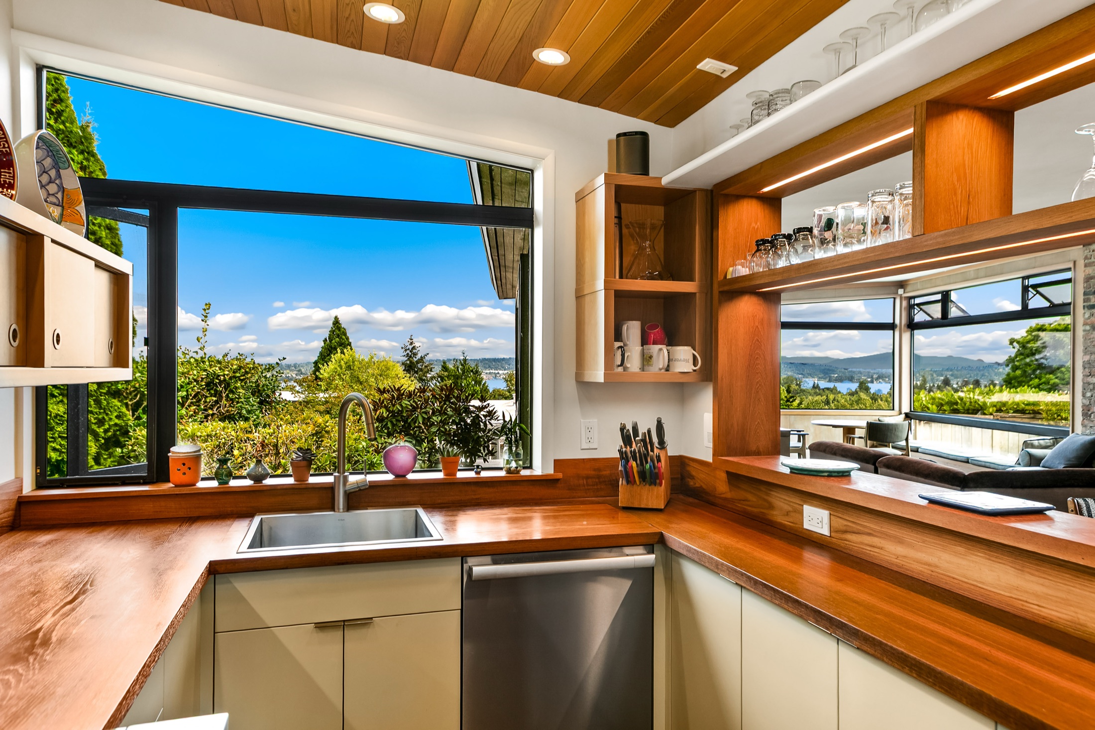 Corner kitchen sink surrounded by warm wood countertops