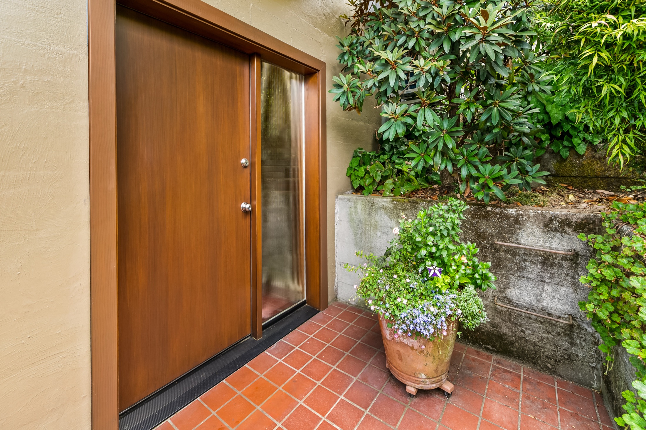 Wood entry door and terracotta tile at the View Ridge home