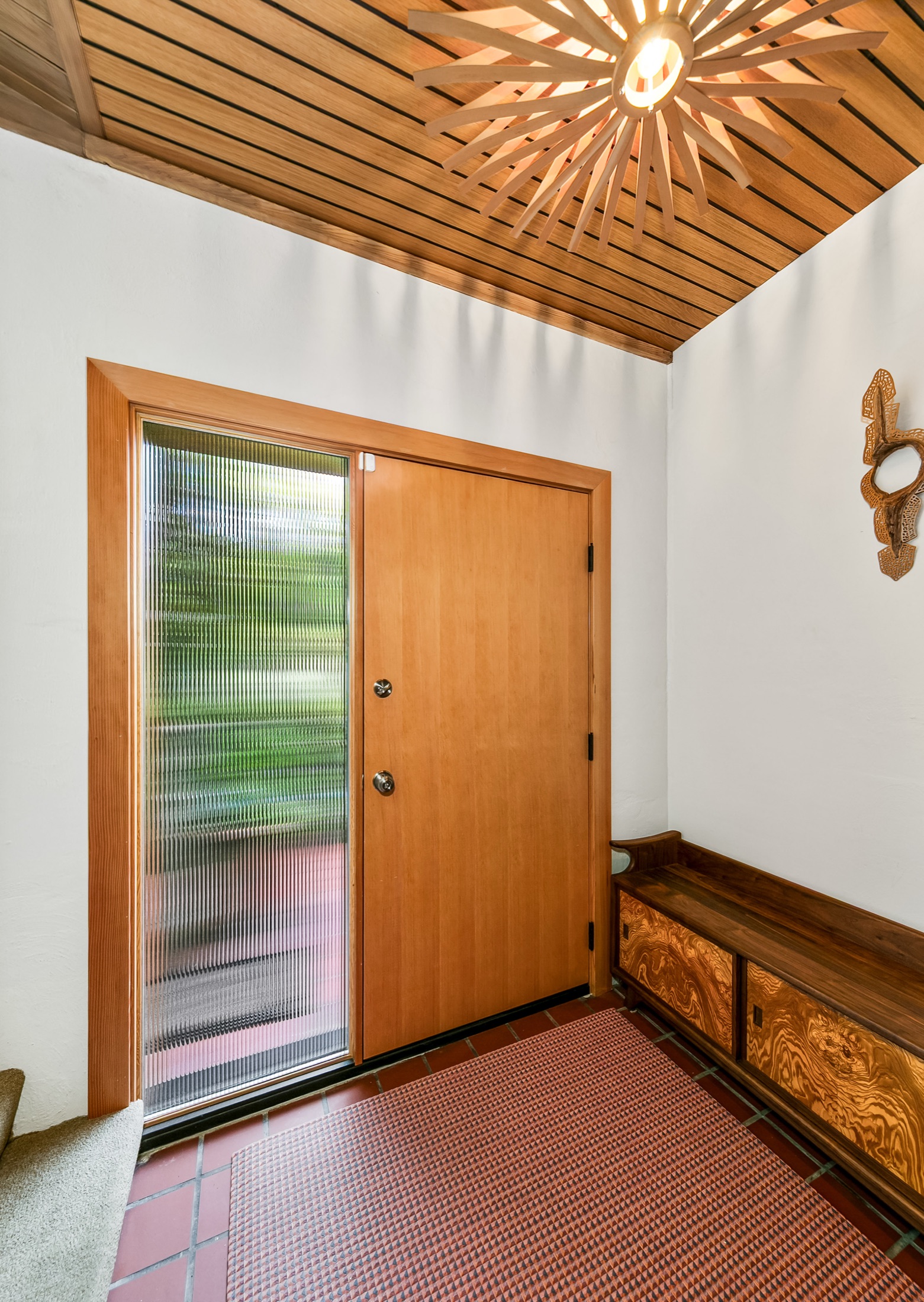 Interior view of the wood entry door and built-in bench
