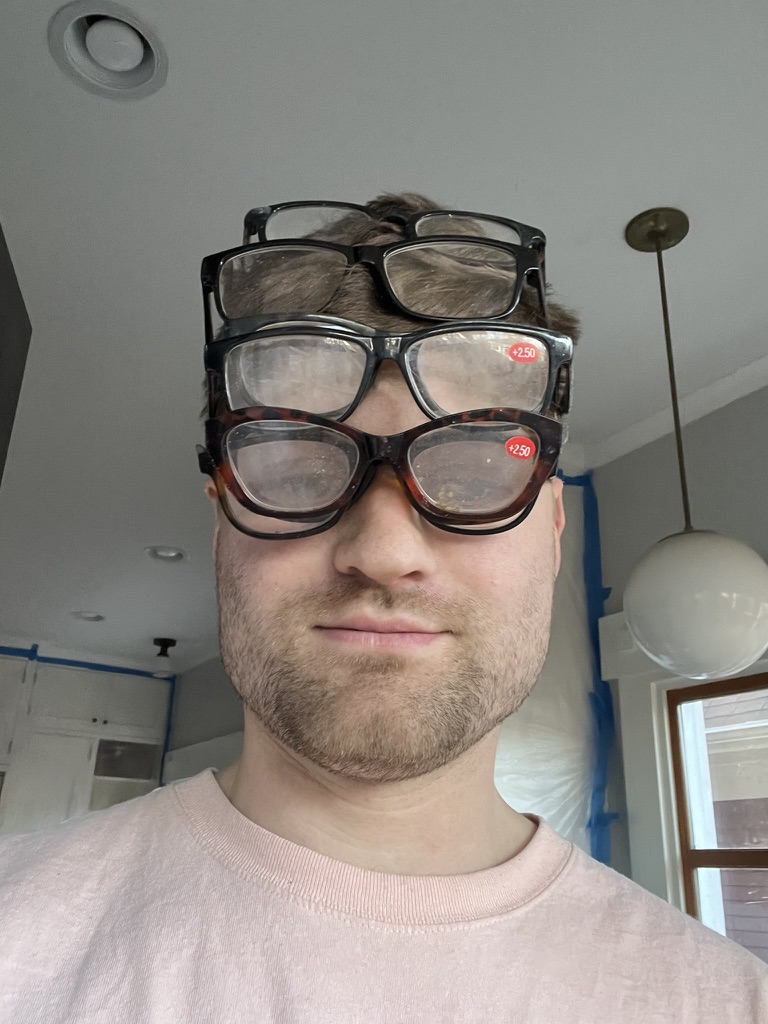 Andy, partner and carpenter, wearing several pairs of glasses