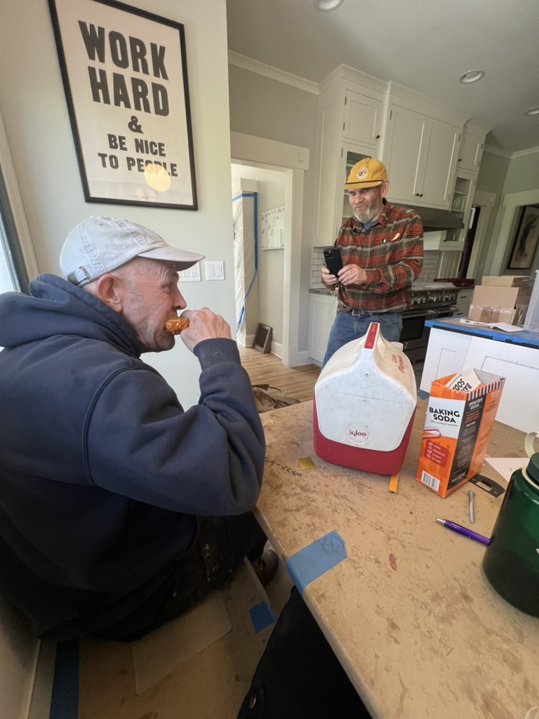 Two A-Carpenter and Team carpenters taking a break in a remodeled kitchen